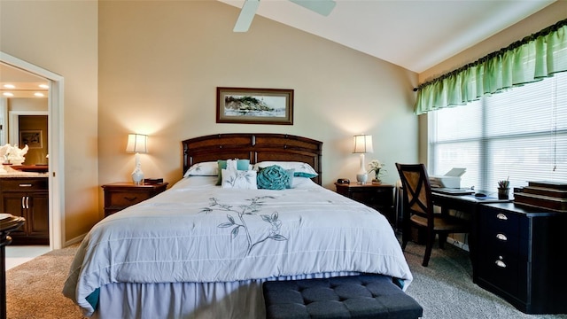 bedroom featuring ensuite bathroom, light carpet, and vaulted ceiling