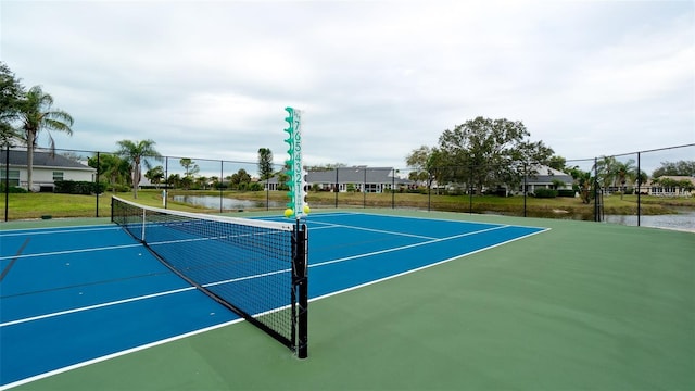 view of sport court featuring basketball court and a water view