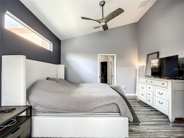 bedroom featuring ceiling fan, dark wood-type flooring, and lofted ceiling