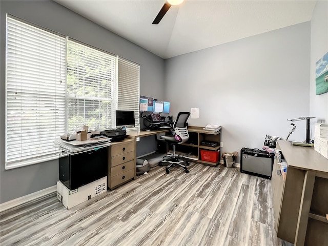 office area featuring vaulted ceiling, light hardwood / wood-style flooring, and ceiling fan