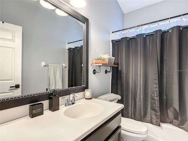 bathroom with walk in shower, vanity, and toilet