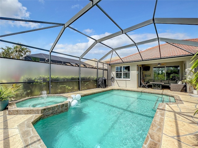 view of pool with an in ground hot tub, an outdoor hangout area, pool water feature, ceiling fan, and glass enclosure