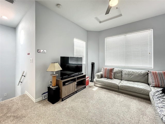 living room featuring carpet floors, attic access, and baseboards