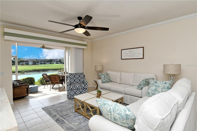 living room featuring ceiling fan, a water view, light tile patterned floors, and crown molding