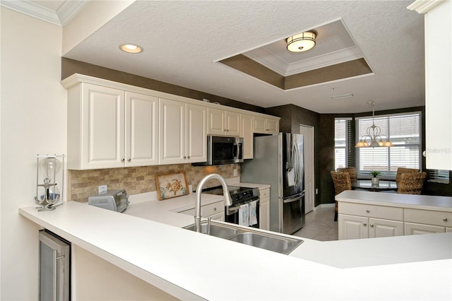 kitchen with wine cooler, white cabinets, an inviting chandelier, and appliances with stainless steel finishes