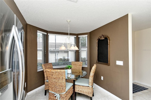 dining space with light tile patterned floors and a textured ceiling