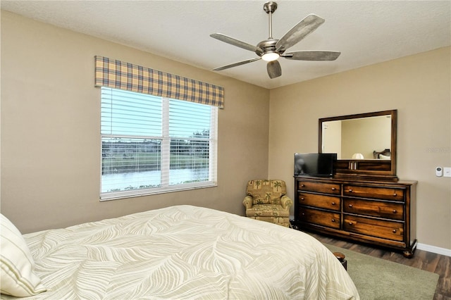 bedroom featuring ceiling fan and dark wood-type flooring