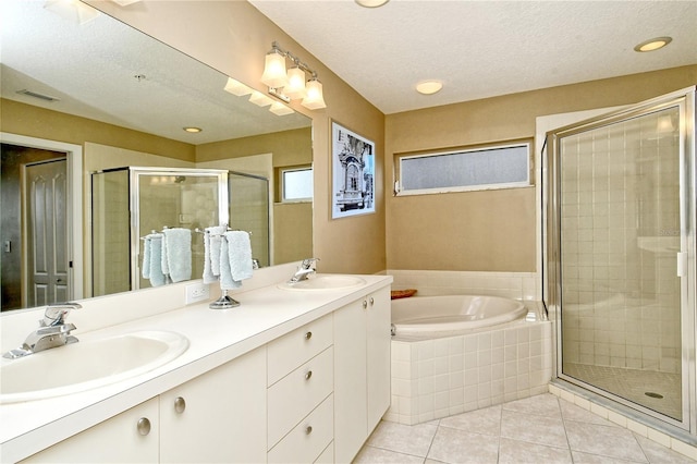 bathroom featuring a textured ceiling, vanity, tile patterned floors, and separate shower and tub