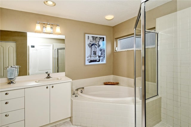 bathroom featuring tile patterned floors, vanity, separate shower and tub, and a textured ceiling