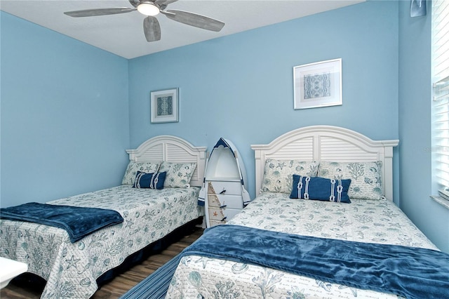 bedroom featuring multiple windows, ceiling fan, and dark hardwood / wood-style floors