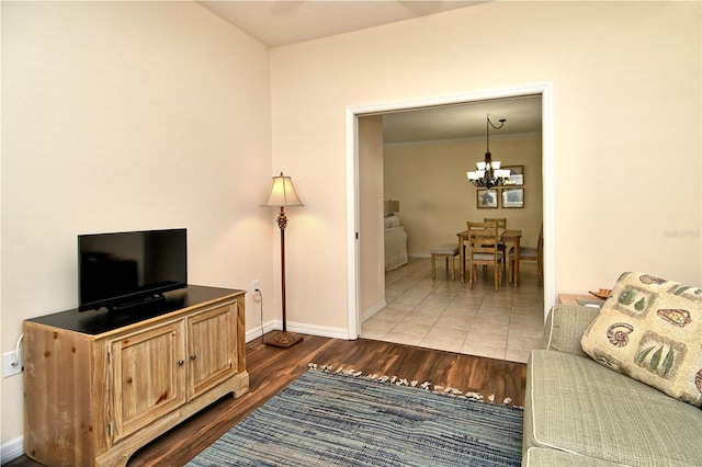 living room with hardwood / wood-style floors and a notable chandelier