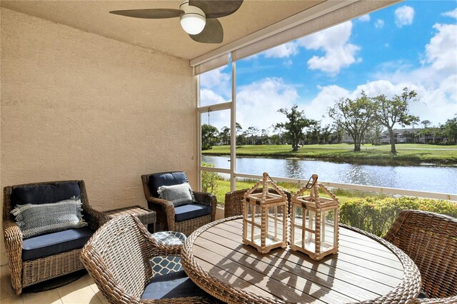 view of patio featuring ceiling fan and a water view