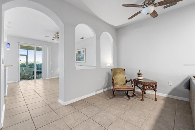 living area with ceiling fan and light tile patterned floors