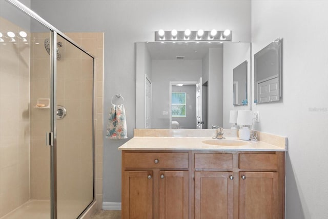 bathroom featuring vanity and a shower with shower door