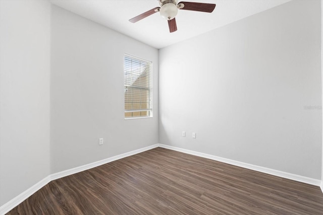 empty room with dark hardwood / wood-style floors and ceiling fan