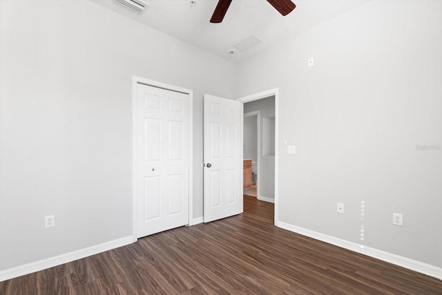 unfurnished bedroom featuring ceiling fan and dark hardwood / wood-style floors