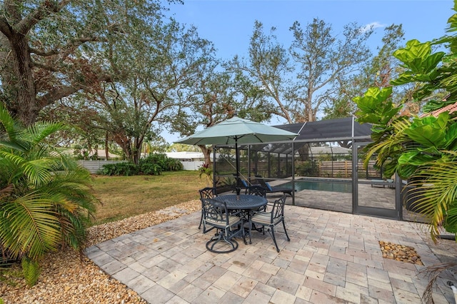 view of patio / terrace featuring glass enclosure and a fenced in pool