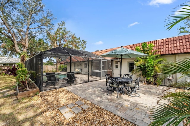 view of patio / terrace featuring glass enclosure