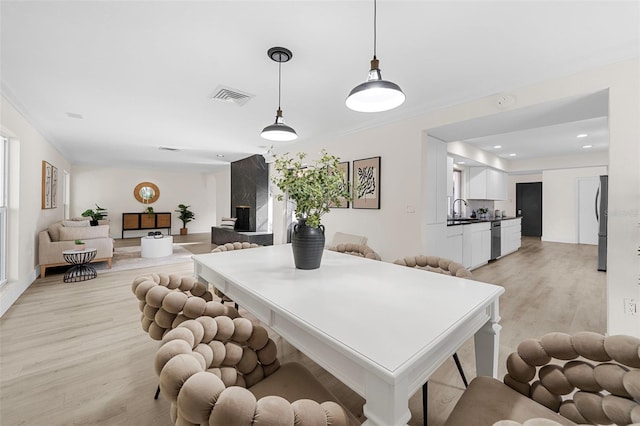 dining room featuring sink and light wood-type flooring