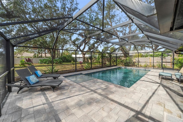 view of swimming pool with a patio and glass enclosure