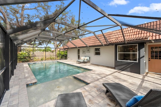 view of swimming pool featuring a lanai, a patio, and an outdoor hangout area