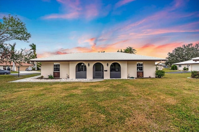 single story home featuring a yard