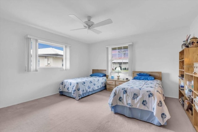 carpeted bedroom with ceiling fan and multiple windows