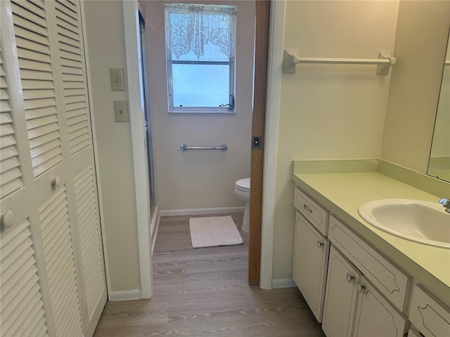 430 Botticelli Dr Unit 430, Nokomis, FL 34275 - bathroom featuring a closet, vanity, wood finished floors, and an enclosed shower