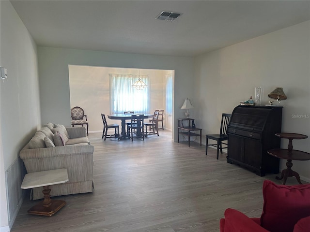430 Botticelli Dr Unit 430, Nokomis, FL 34275 - living room featuring wood finished floors and a chandelier