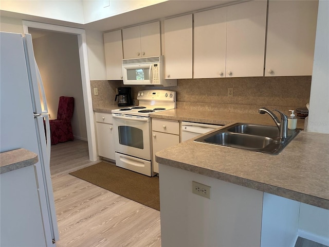 430 Botticelli Dr Unit 430, Nokomis, FL 34275 - kitchen featuring white appliances, light wood-style floors, tasteful backsplash, and white cabinets