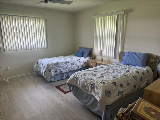 430 Botticelli Dr Unit 430, Nokomis, FL 34275 - bedroom with multiple windows, wood finished floors, and a ceiling fan