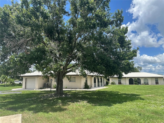 430 Botticelli Dr Unit 430, Nokomis, FL 34275 - view of front of home with a garage, a front lawn, and stucco siding