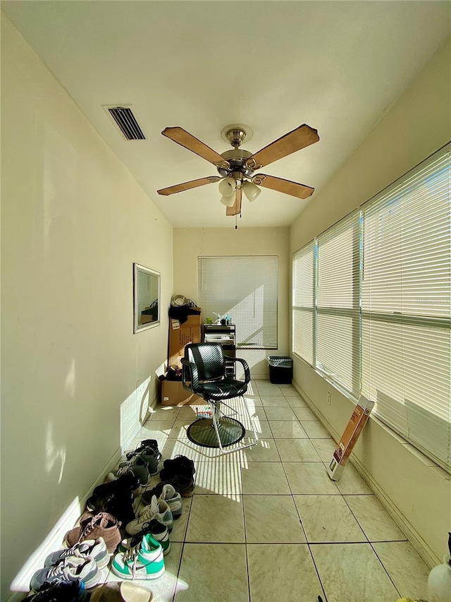 sunroom featuring ceiling fan