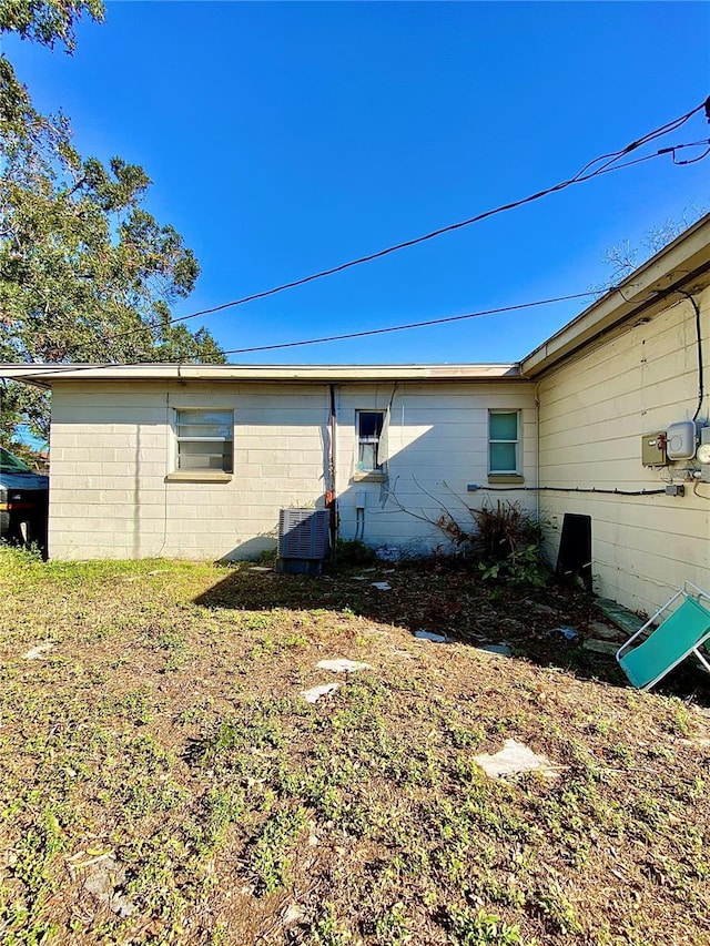 view of side of property featuring central air condition unit