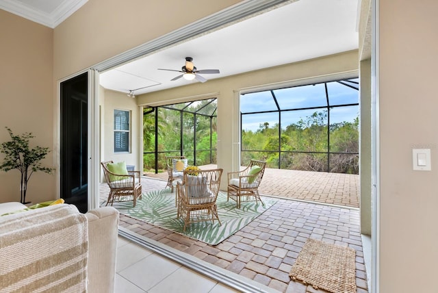 sunroom / solarium featuring ceiling fan