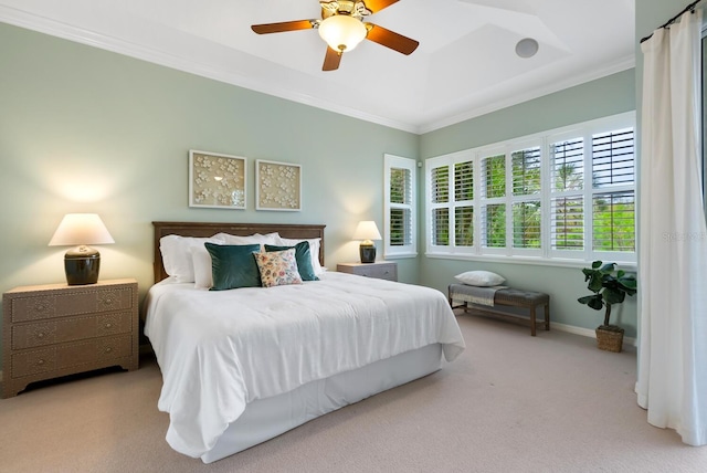 carpeted bedroom with ceiling fan and ornamental molding