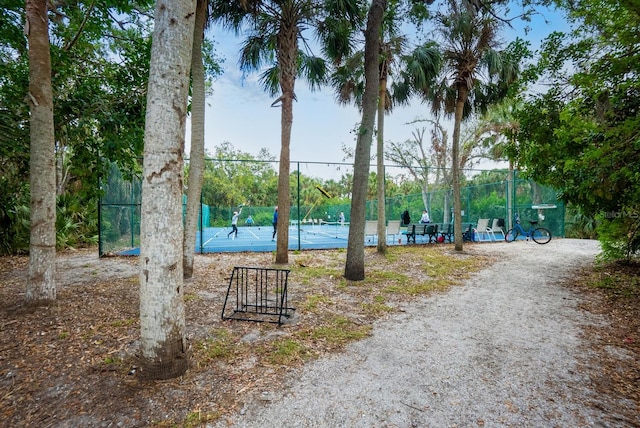 view of home's community with tennis court