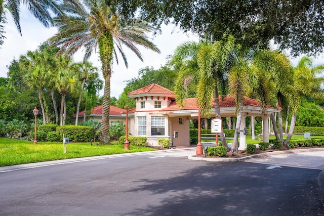 mediterranean / spanish-style house featuring a front yard