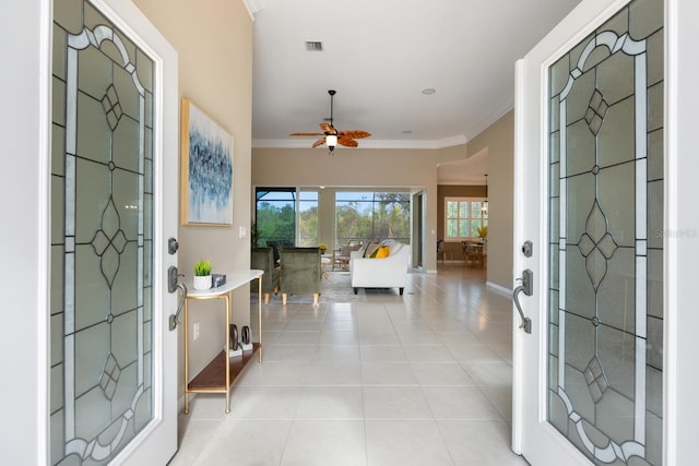 entryway featuring crown molding, light tile patterned floors, and ceiling fan