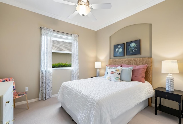 carpeted bedroom with crown molding and ceiling fan