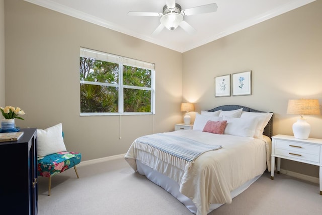 bedroom with crown molding, light colored carpet, and ceiling fan