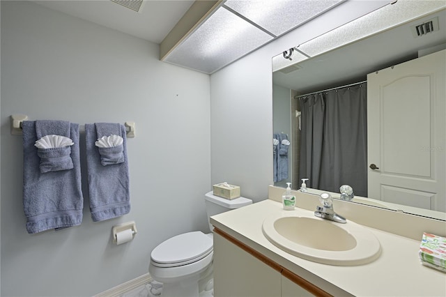 bathroom featuring toilet and vanity