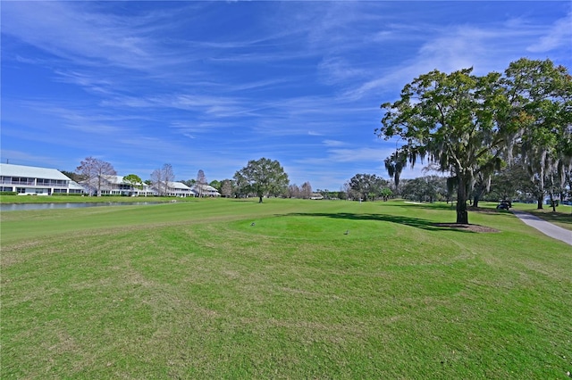 surrounding community featuring a water view and a yard