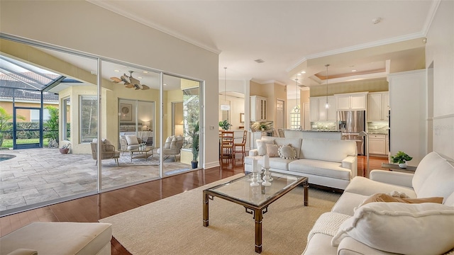 living room with light hardwood / wood-style flooring and crown molding