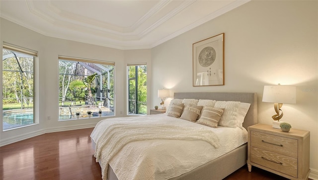 bedroom with a tray ceiling, crown molding, and dark wood-type flooring