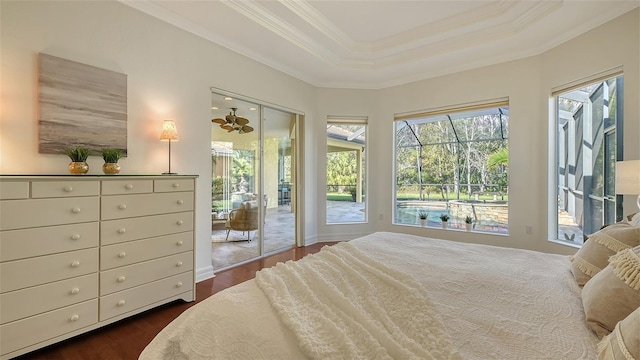 bedroom featuring a raised ceiling, dark hardwood / wood-style floors, access to exterior, and ornamental molding