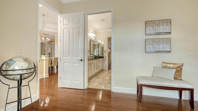 hall featuring wood-type flooring and crown molding