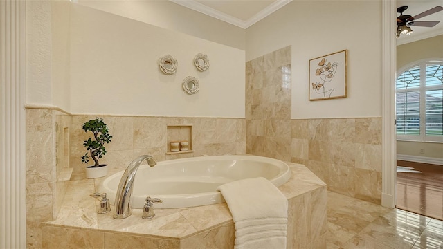 bathroom with tiled bath, crown molding, and ceiling fan