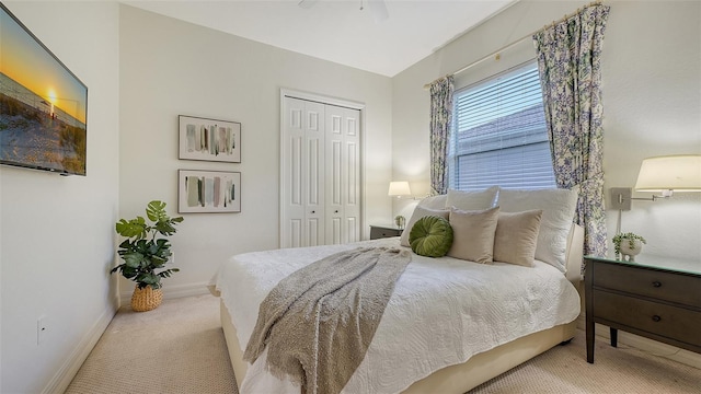 carpeted bedroom featuring a closet and ceiling fan