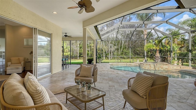 view of patio with an outdoor living space, ceiling fan, a lanai, and a pool with hot tub